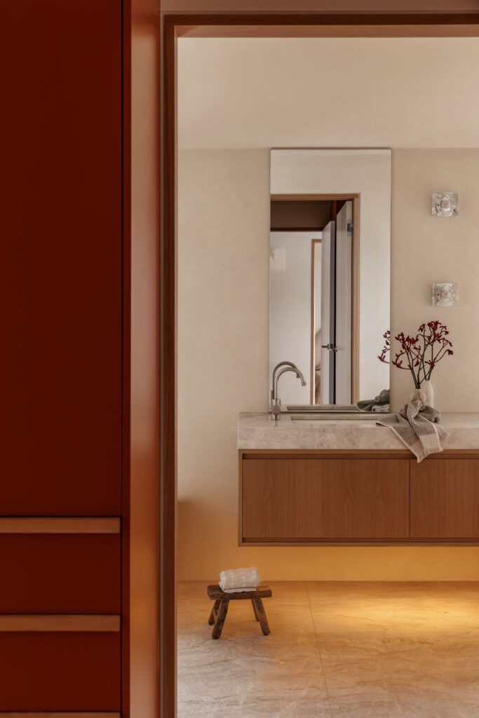 Bathroom with wooden cabinetry and stone countertop