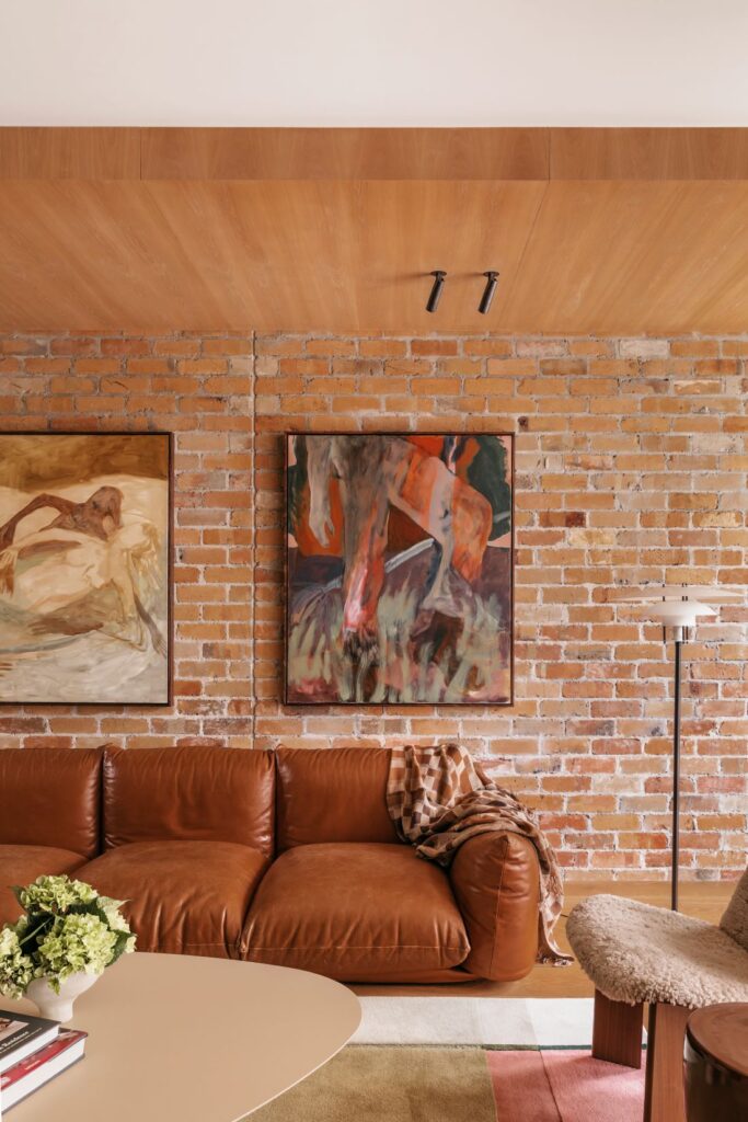 Modern living room with leather sofa and brick wall