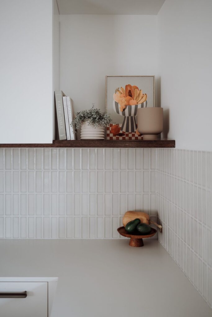 Minimalist kitchen shelf styling with organic elements