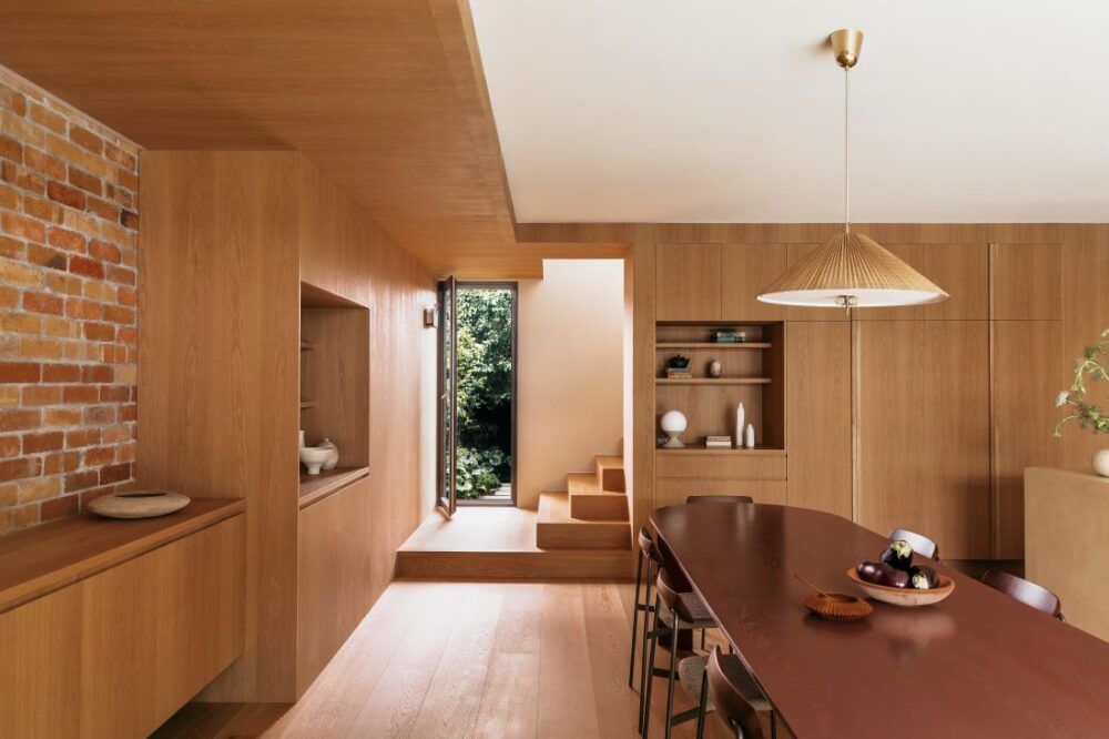 Alt Text: Spacious kitchen and dining area with brick feature
