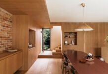 7 home lighting mistakes and how to avoid them Alt Text: Spacious kitchen and dining area with brick feature