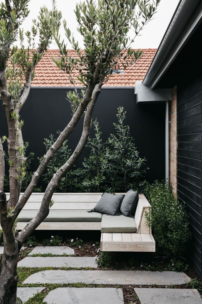Outdoor corner bench seating with greenery