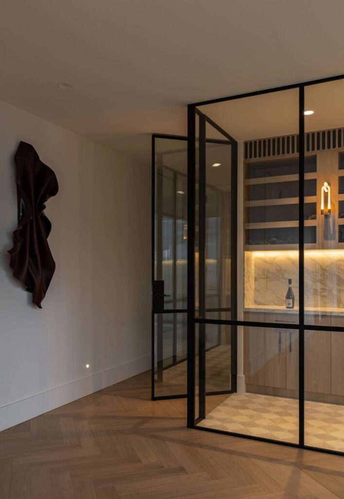 Glass-enclosed wine cellar view from hallway