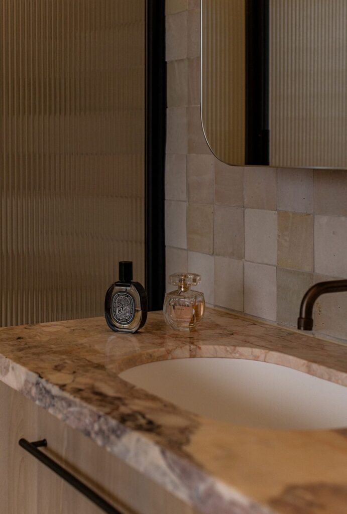 Marble vanity detail with luxury perfume bottles