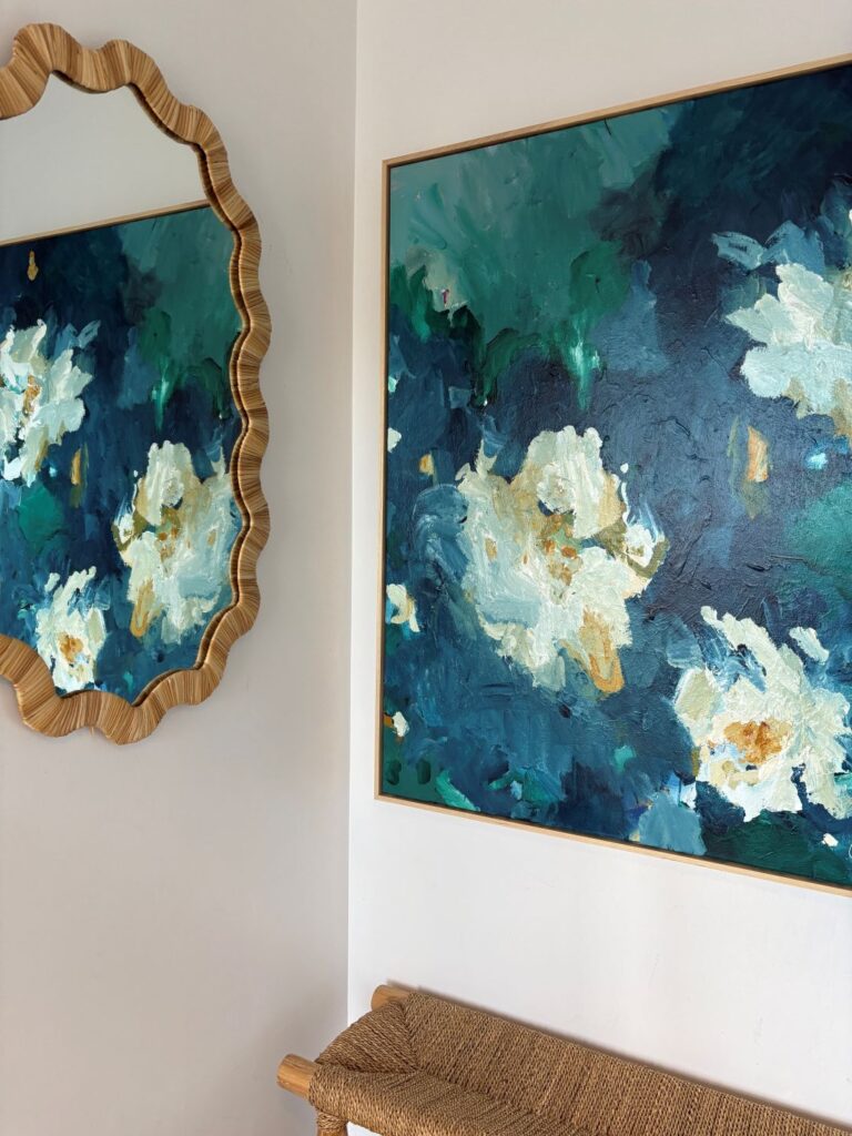 Teal floral canvas styled with scalloped rattan mirror