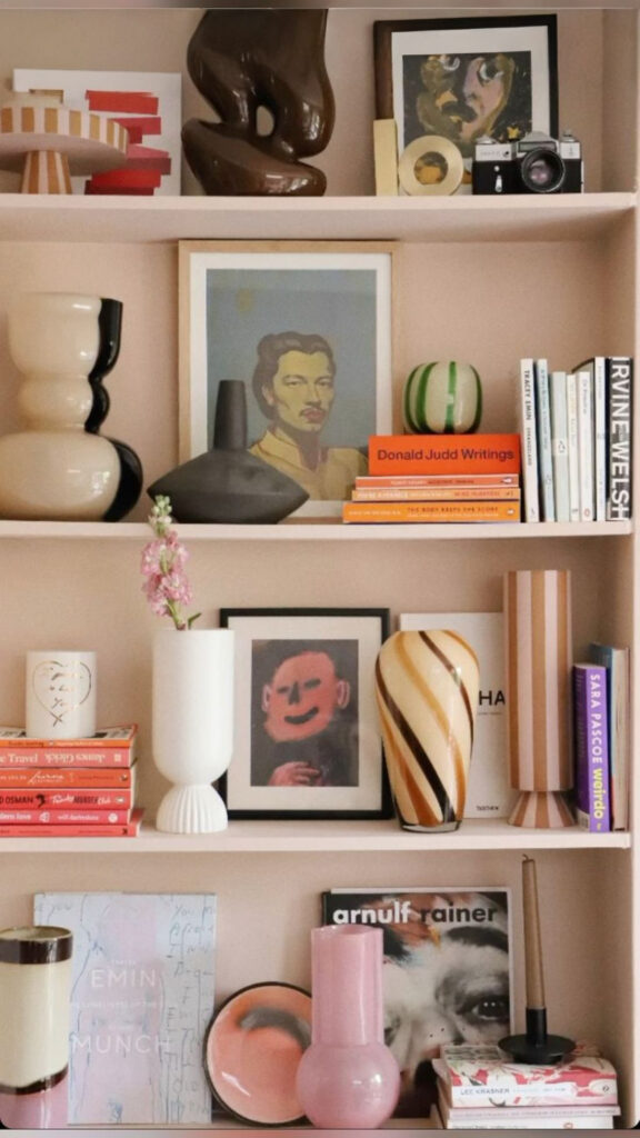 Bookshelf styling with decor, flowers and art