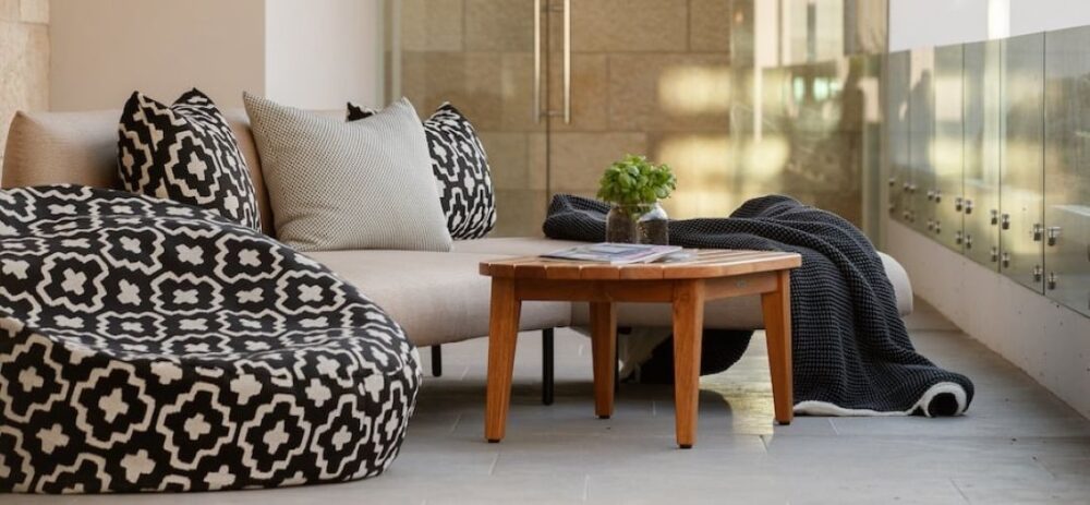 Outdoor lounge setting with patterned bean bag and teak table
