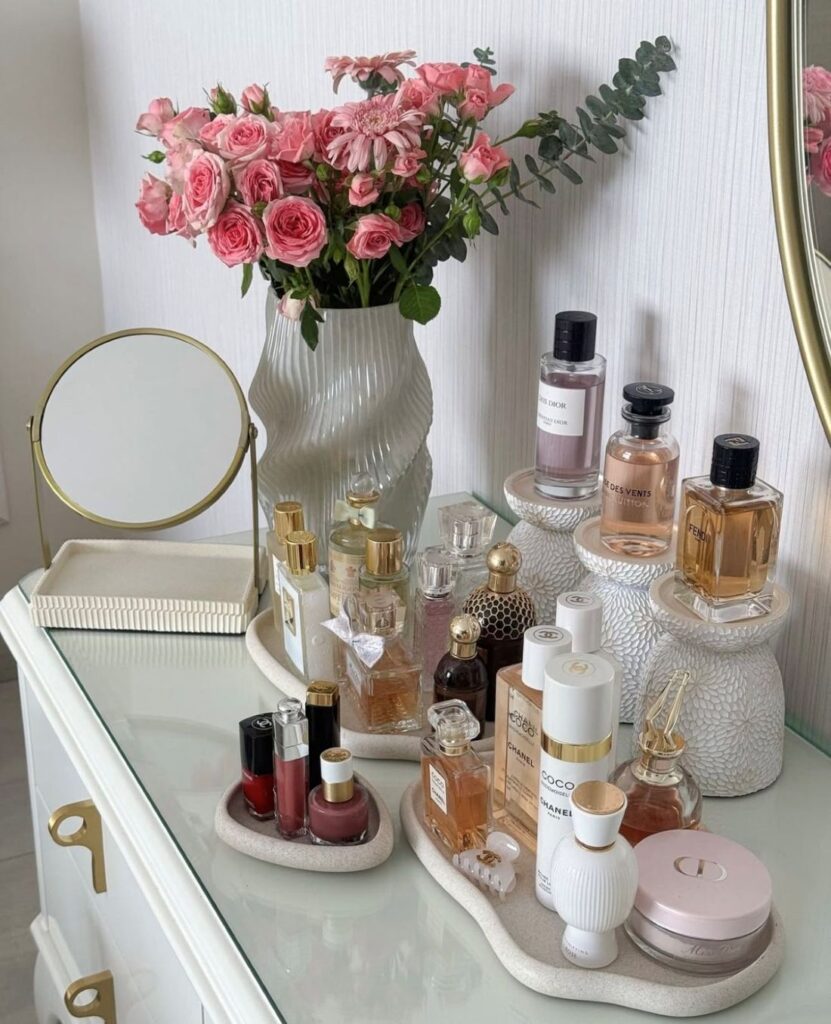 Pink roses bouquet on vanity with luxury perfume bottles
