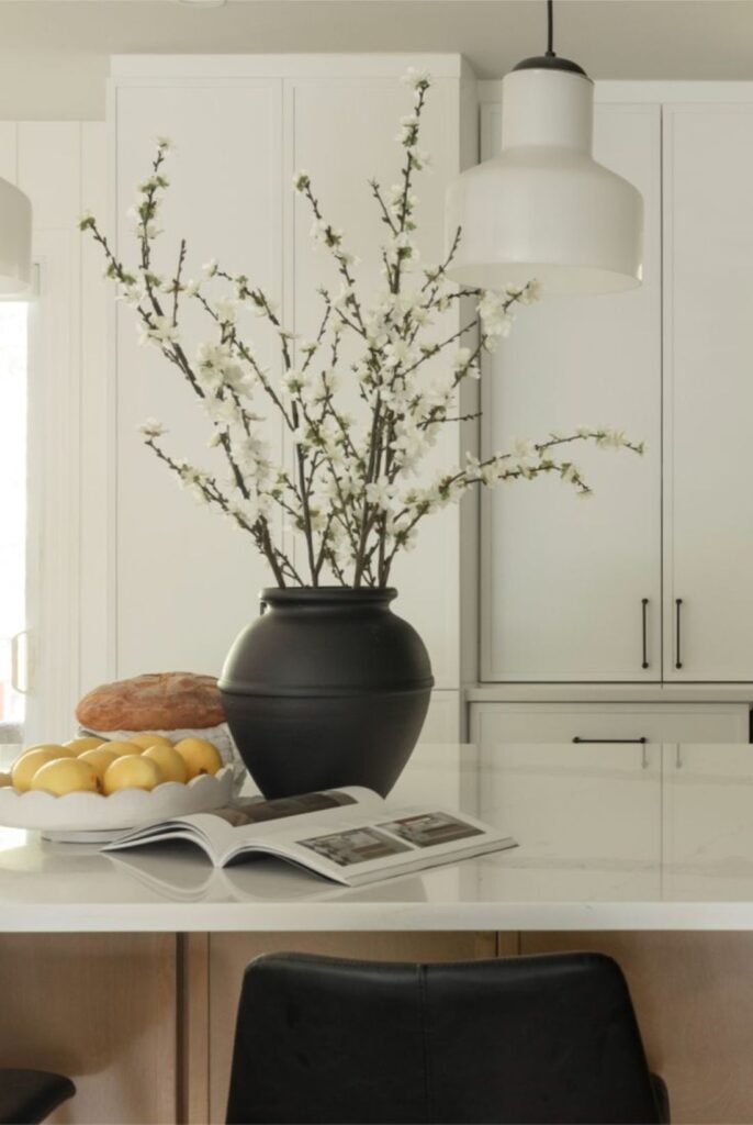 White blossom branches on marble kitchen island