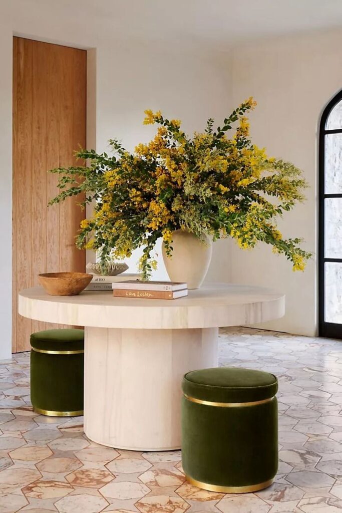 Yellow wattle arrangement on round marble table